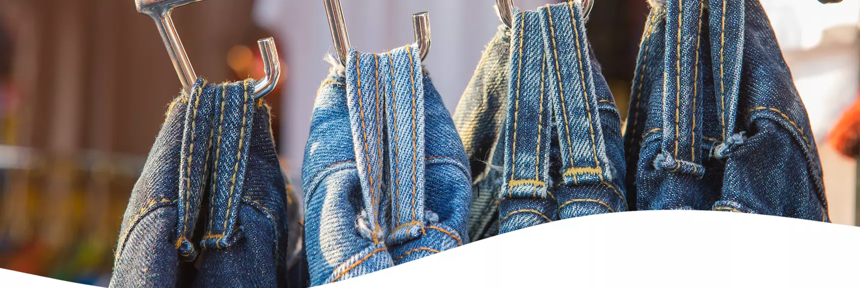 A store display of jeans illustrates a discussion by apparel industry experts on garment durability and fast vs. slow fashion.