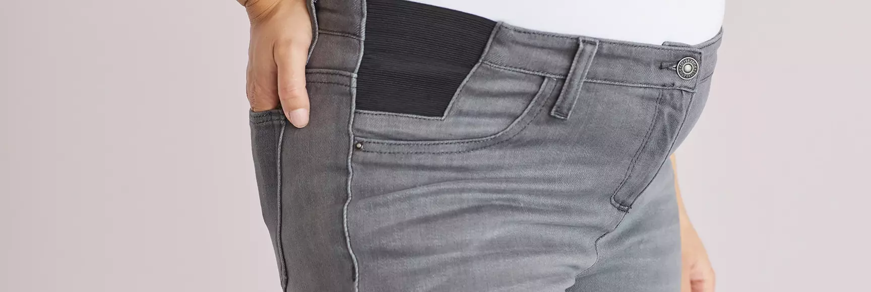 A woman wearing a Maternity Super Soft Skinny Jeans by NEXT brand with LYCRA® dualFX® technology